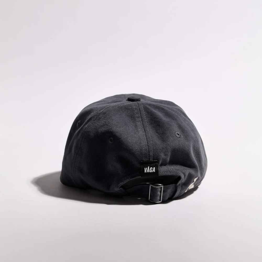 Black cap with 'Vaga' logo on a light gray background