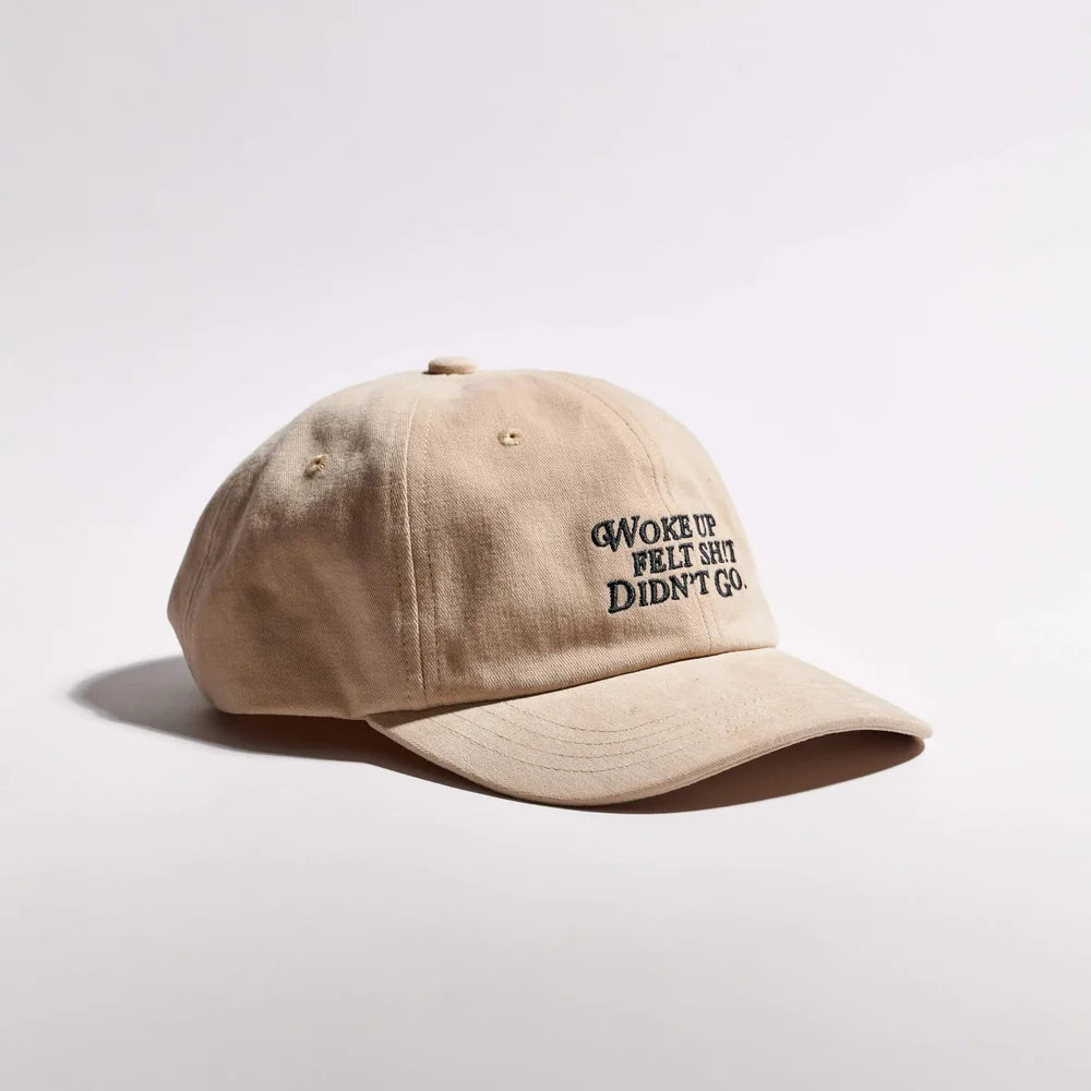 Beige cap with text on a light gray background