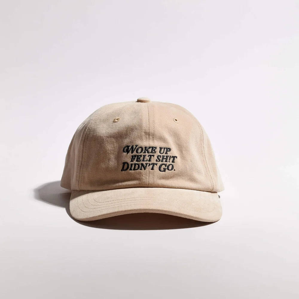 Beige cap with black text on a light gray background