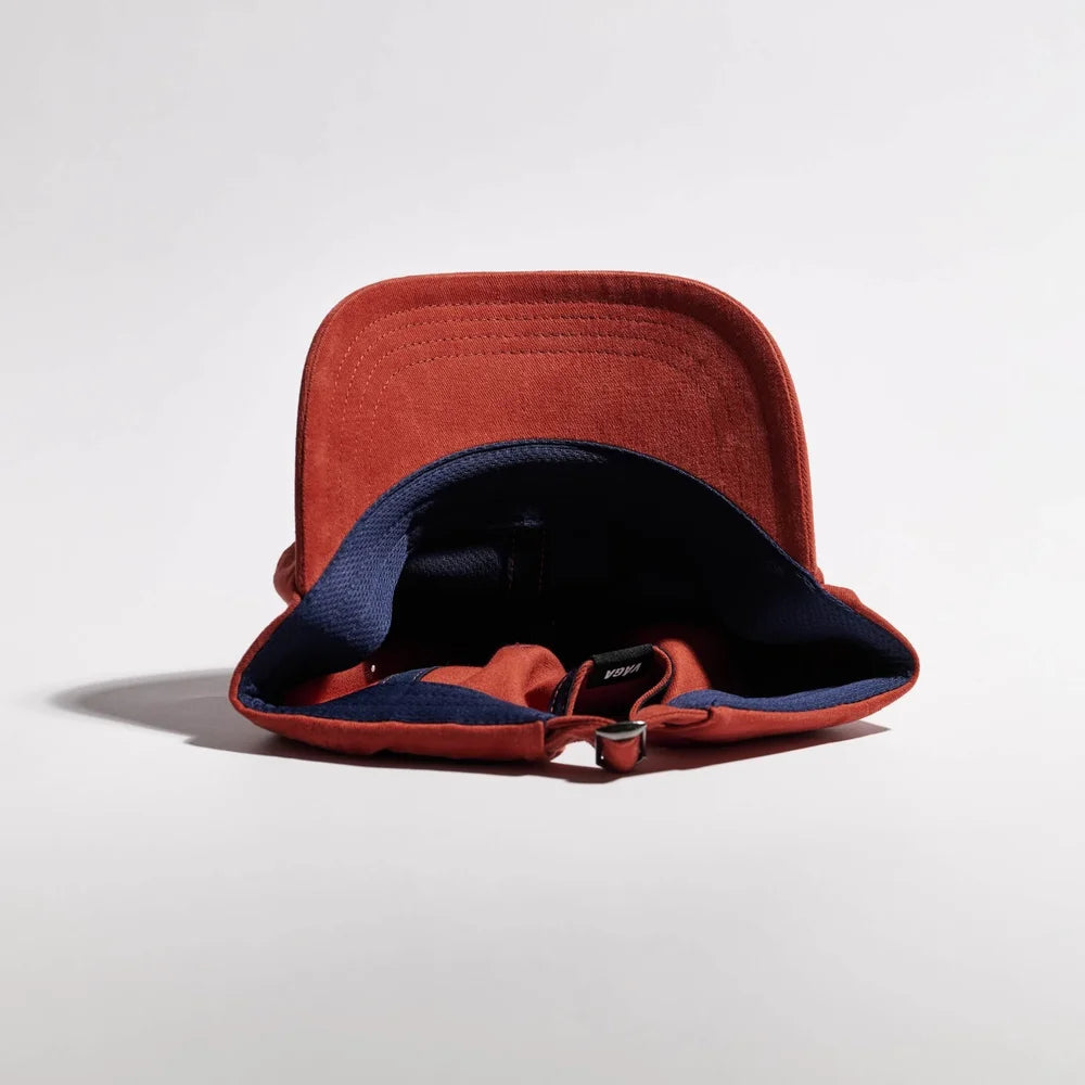 Red bucket hat with blue interior on a light gray background