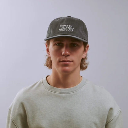 Person wearing a cap with text on a plain background