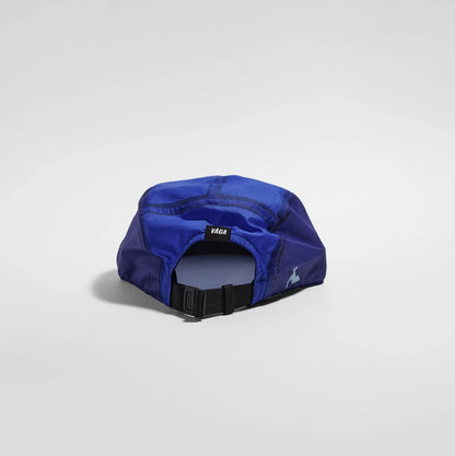 A royal blue athletic cap shown from the back, featuring a black adjustable strap and a small black brand patch with white text.