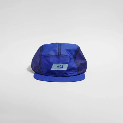 Blue cap with 'Vága' logo on a white background