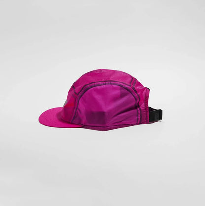A bright magenta pink 5-panel cap with a matching flat brim and a black adjustable strap, shown from a side profile on a light gray background.