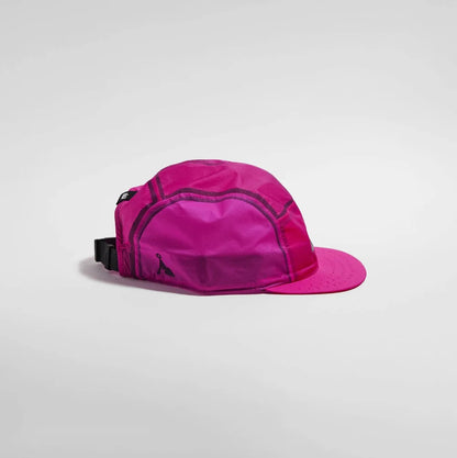 A bright pink cap with a structured crown, matching pink flat brim, and a black adjustable strap closure, shown on a light gray background.