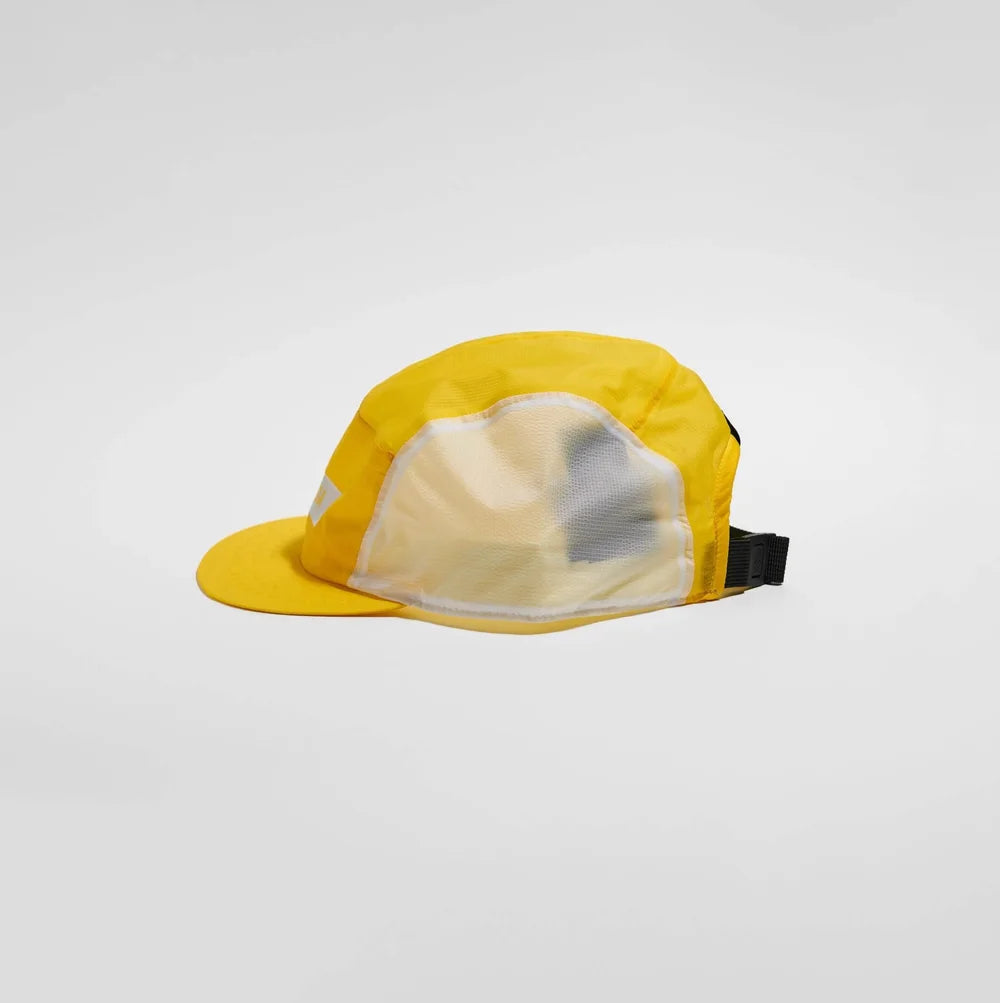 A yellow 5-panel cap with a mesh back and a black adjustable strap, photographed on a light gray studio background.