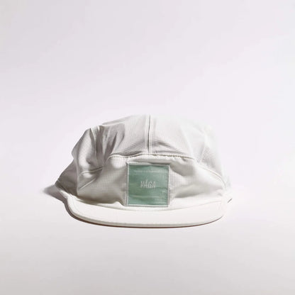White cap with a brand label on a light gray background