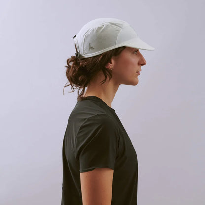 Person wearing a white cap and black t-shirt against a plain background