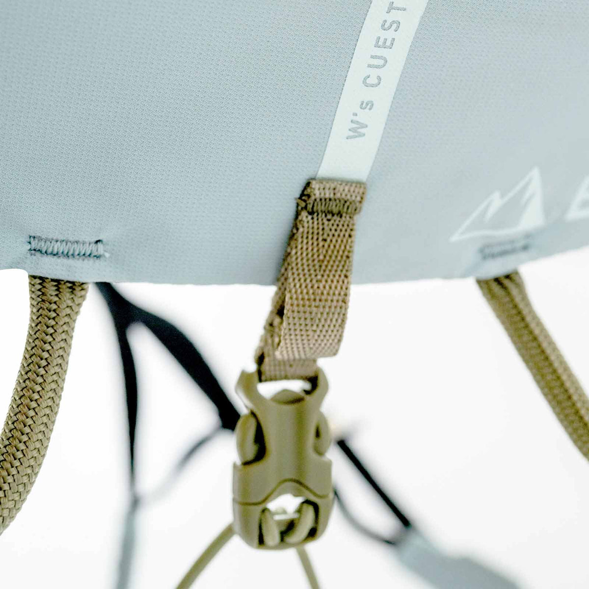 Light blue climbing harness with webbing straps and “Cuesta Adj” tag on the panel