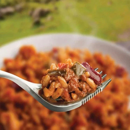 Spoonful of chili con carne with rice, garnished with beans